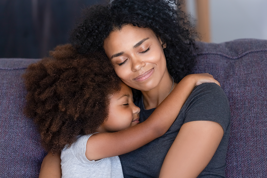 Mother hugging daughter