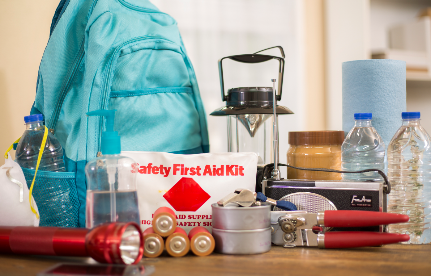 Example of hurricane supplies including water, flashlight, batteries, first aid kit, peanutbutter, radio