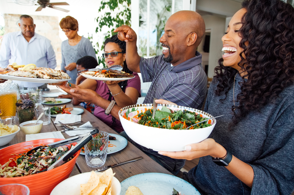 Family passing food around a table