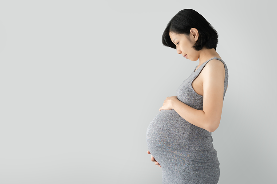 Pregnant woman cradling her stomach